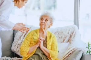 Elderly woman being yelled at by nurse to show nursing home abuse